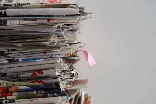 Tall pile of newspapers for the guide on publishing a press release on USA Today
