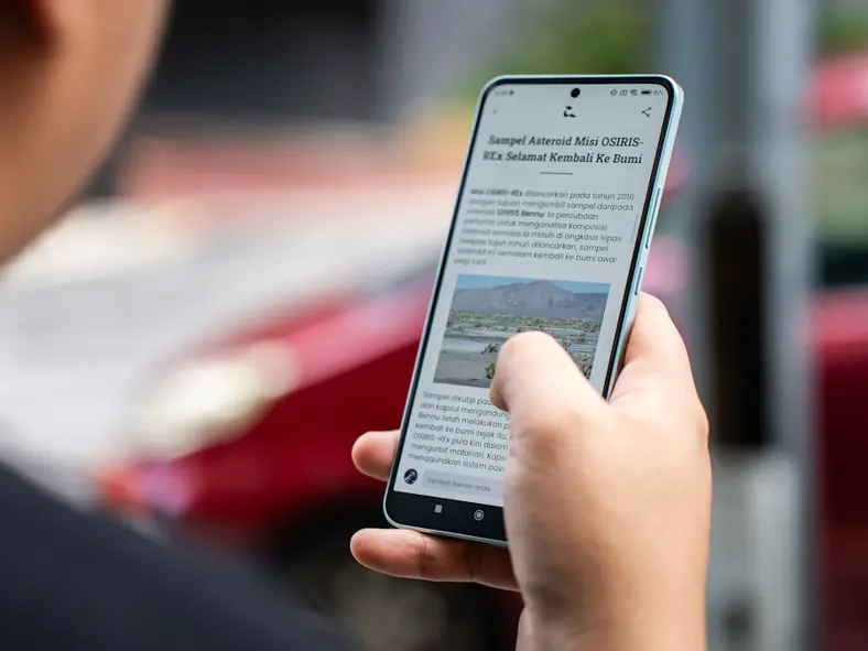 Person reading a published press release on a smartphone