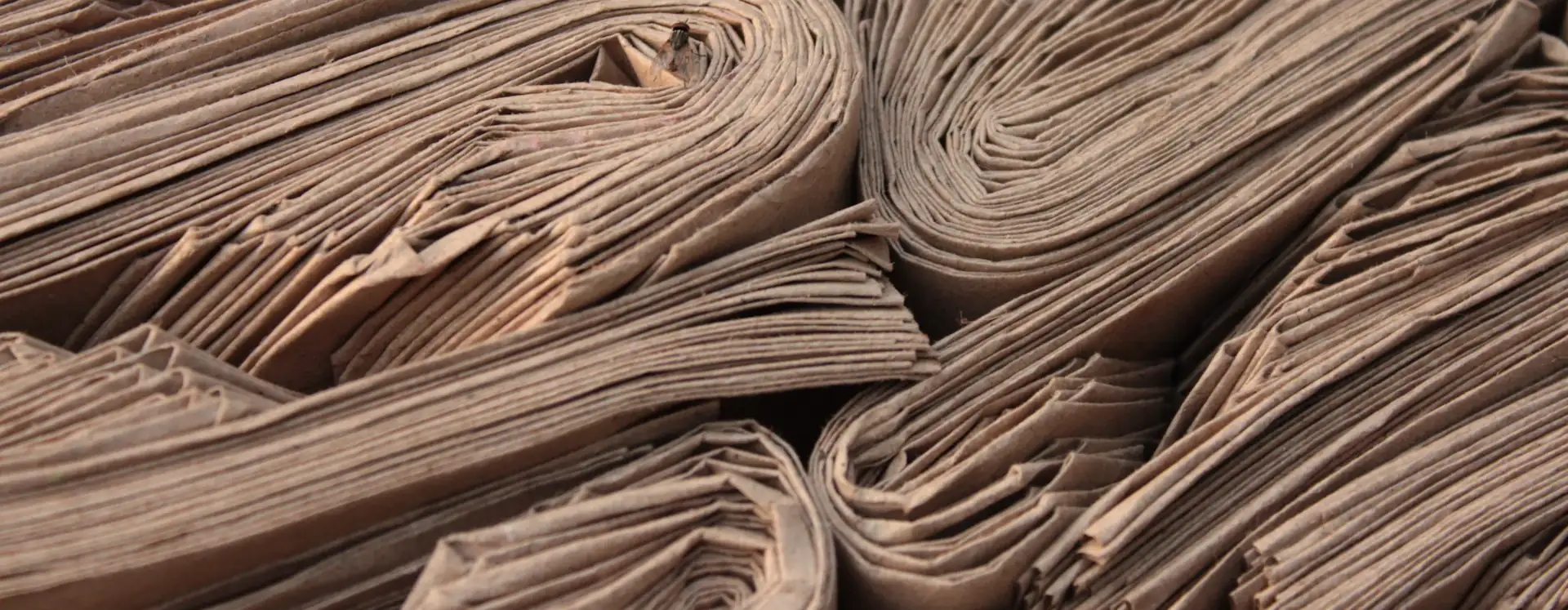 Rolled newspapers stacked together